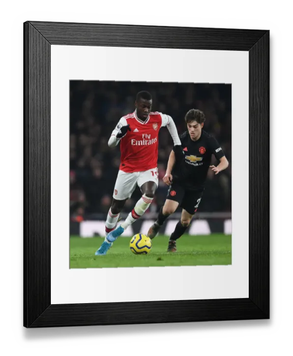 Framed Print : Pepe Outsmarts James: Arsenal's Star Winger Outmaneuvers Manchester United's Defender in Thrilling Premier League Showdown