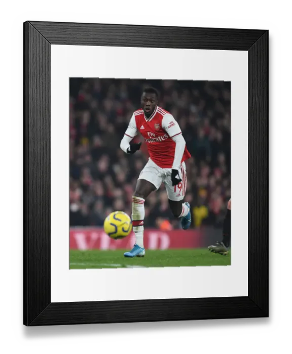 Framed Print : Nicolas Pepe vs Manchester United: Arsenal's Star Forward Faces Off at the Emirates Stadium