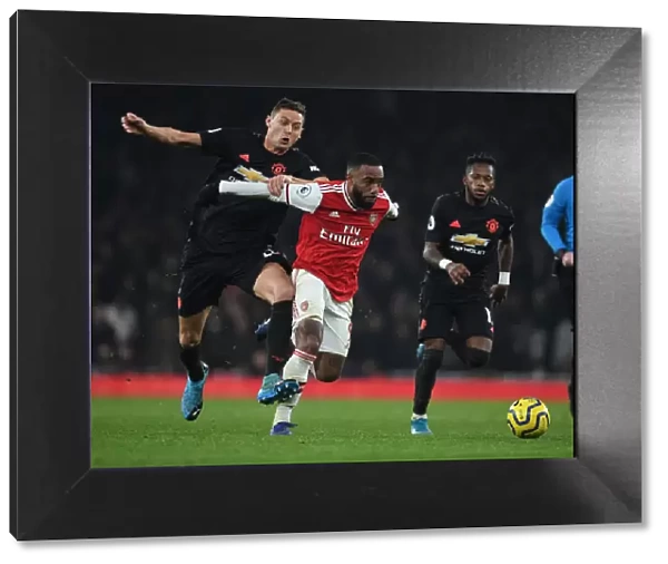 Arsenal's Alex Lacazette Outmaneuvers Manchester United's Matic and Fred during the 2019-20 Premier League Clash