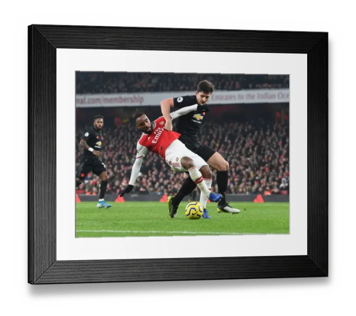 Framed Print : Lacazette vs Maguire: A Premier League Showdown at Emirates Stadium