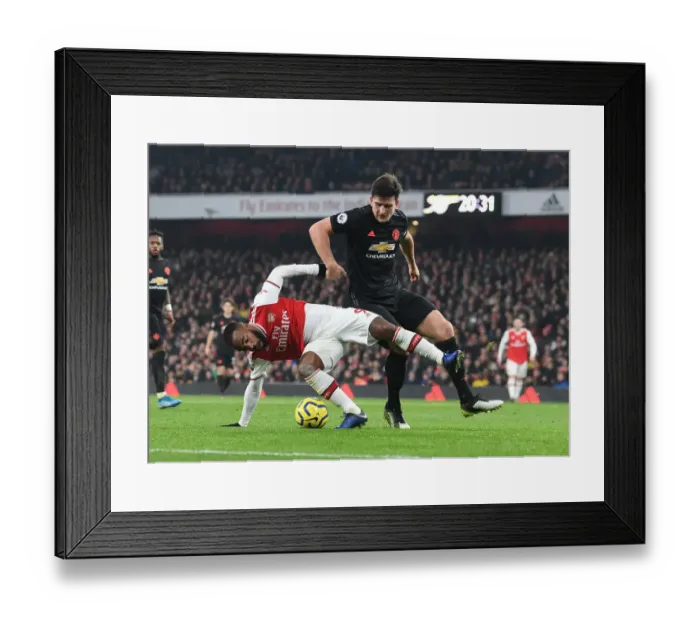 Framed Print : Arsenal vs Manchester United: Lacazette vs Maguire - Premier League Showdown (2019-20): A Battle of Stars at Emirates Stadium