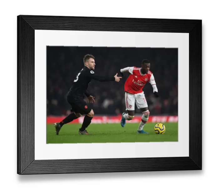 Framed Print : Arsenal's Nicolas Pepe Clashes with Manchester United's Luke Shaw in Premier League Showdown Framed Print : Arsenal's Nicolas Pepe Clashes with Manchester United's Luke Shaw in Premier League Showdown