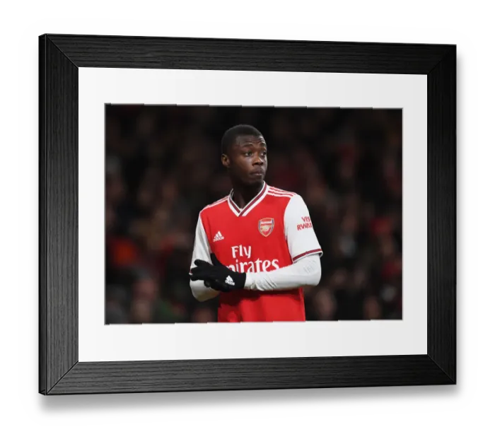 Framed Print : Arsenal's Nicolas Pepe Faces Off Against Manchester United in Premier League Showdown Framed Print : Arsenal's Nicolas Pepe Faces Off Against Manchester United in Premier League Showdown