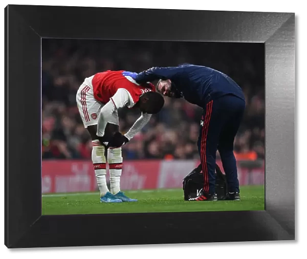 Arsenal's Nicolas Pepe Receives Treatment from Physio during Arsenal v Manchester United (2019-20)