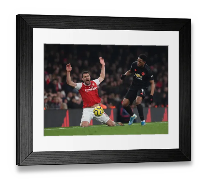 Framed Print : Arsenal vs Manchester United: Sokratis Fouls Anthony Martial in Intense Premier League Clash (2019-20)