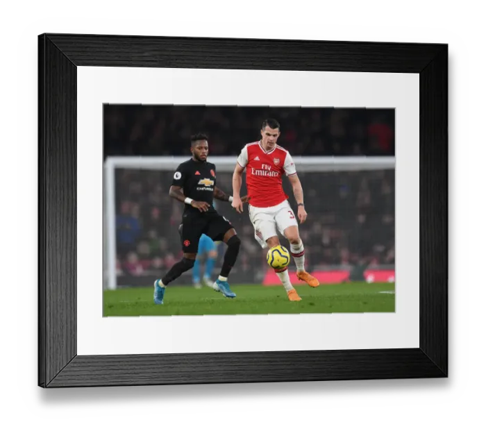Framed Print : Arsenal's Xhaka Clashes with Manchester United's Fred in Intense Premier League Showdown Framed Print : Arsenal's Xhaka Clashes with Manchester United's Fred in Intense Premier League Showdown