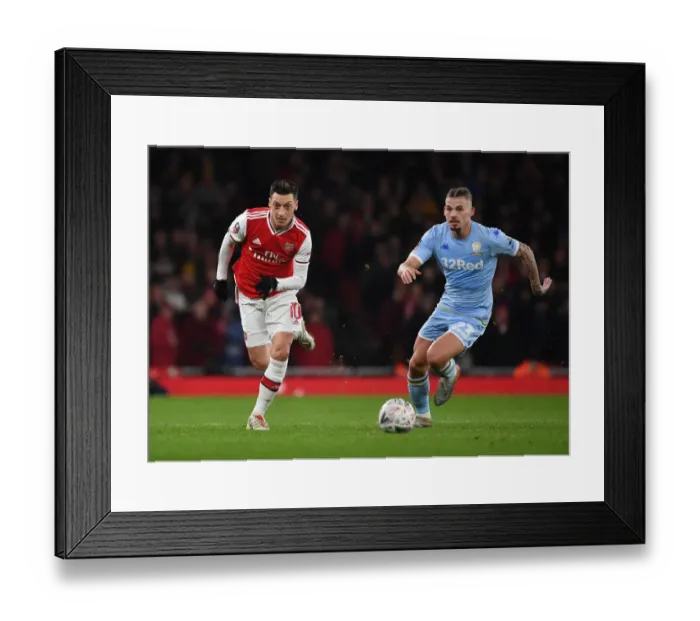 Framed Print : Arsenal's Mesut Ozil Outmaneuvers Leeds Kalvin Phillips in FA Cup Clash Framed Print : Arsenal's Mesut Ozil Outmaneuvers Leeds Kalvin Phillips in FA Cup Clash