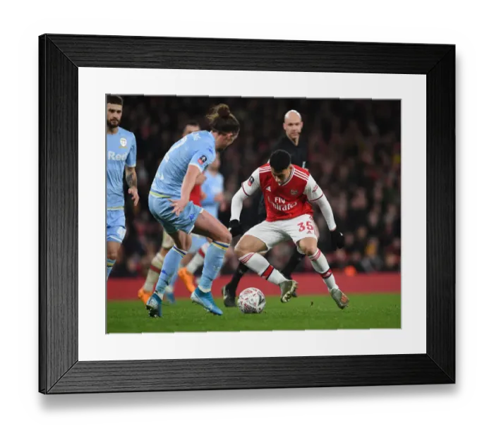 Framed Print : Arsenal's Martinelli Clashes with Leeds Ayling in FA Cup Showdown