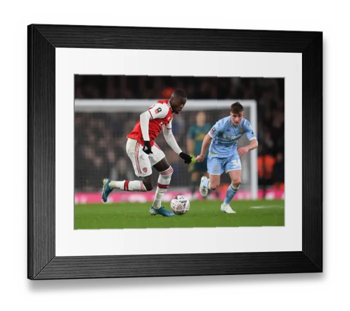 Framed Print : Arsenal's Nicolas Pepe Clashes with Leeds United's Robbie Gotts in FA Cup Third Round
