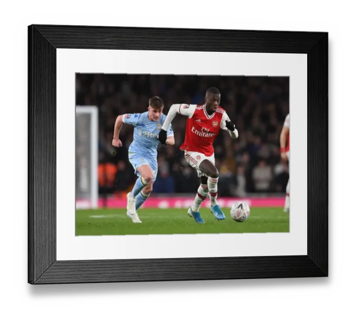 Framed Print : Arsenal's Nicolas Pepe Clashes with Leeds Robbie Gotts in FA Cup Third Round