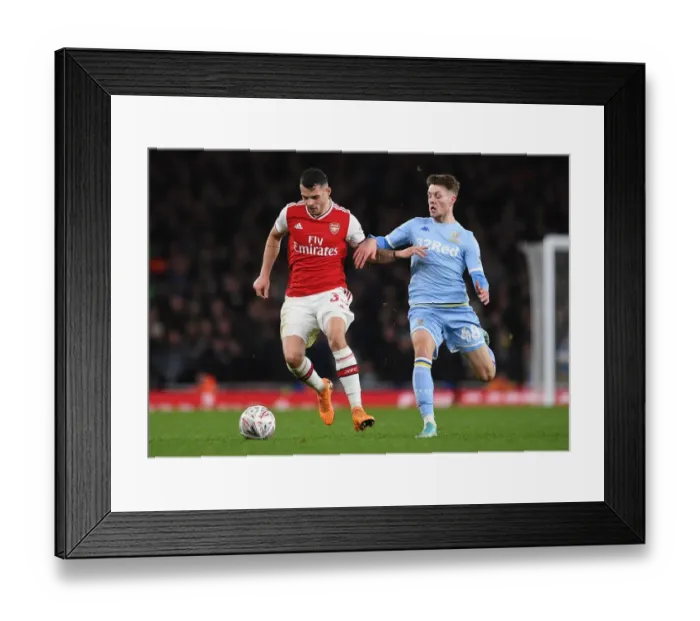Framed Print : Arsenal's Granit Xhaka Clashes with Leeds Jordan Stevens in FA Cup Showdown