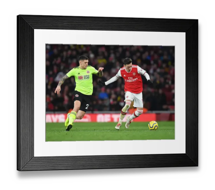 Framed Print : Intense Clash: Ozil vs. Baldock in Arsenal vs. Sheffield United Premier League Showdown