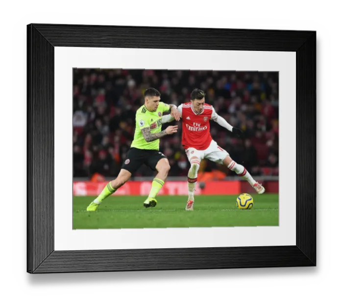 Framed Print : Intense Clash: Ozil vs. Baldock in Arsenal's Premier League Battle against Sheffield United Framed Print : Intense Clash: Ozil vs. Baldock in Arsenal's Premier League Battle against Sheffield United