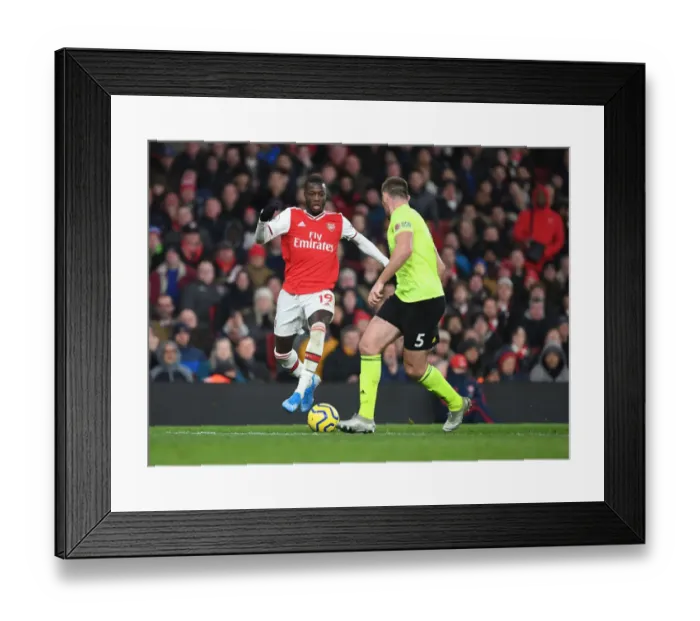 Framed Print : Arsenal's Nicolas Pepe Clashes with Sheffield United's Jack O'Connell in Premier League Showdown Framed Print : Arsenal's Nicolas Pepe Clashes with Sheffield United's Jack O'Connell in Premier League Showdown