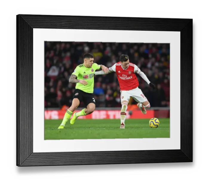 Framed Print : Intense Rivalry: Ozil vs. Baldock - Arsenal's Battle Against Sheffield United
