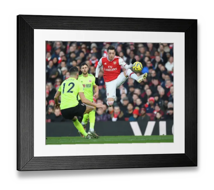 Framed Print : Intense Rivalry: Ozil vs. Egan - Arsenal vs. Sheffield United Clash in the Premier League Framed Print : Intense Rivalry: Ozil vs. Egan - Arsenal vs. Sheffield United Clash in the Premier League