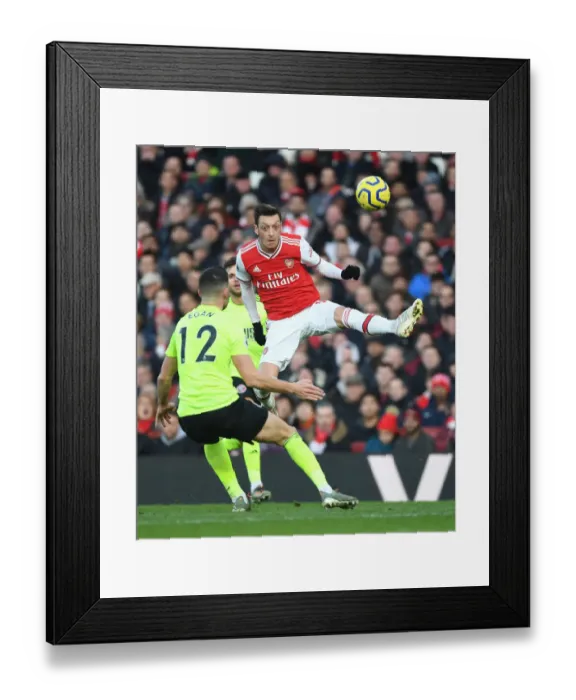 Framed Print : Arsenal's Mesut Ozil Clashes with Sheffield United's John Egan in Premier League Showdown Framed Print : Arsenal's Mesut Ozil Clashes with Sheffield United's John Egan in Premier League Showdown