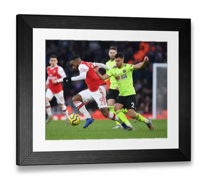 Framed Print : Arsenal's Lacazette Clashes with Sheffield United's Baldock in Premier League Showdown Framed Print : Arsenal's Lacazette Clashes with Sheffield United's Baldock in Premier League Showdown