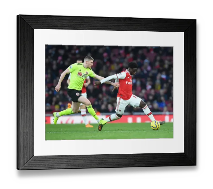 Framed Print : Intense Battle: Bukayo Saka vs. John Lundstram in Arsenal's Clash Against Sheffield United Framed Print : Intense Battle: Bukayo Saka vs. John Lundstram in Arsenal's Clash Against Sheffield United