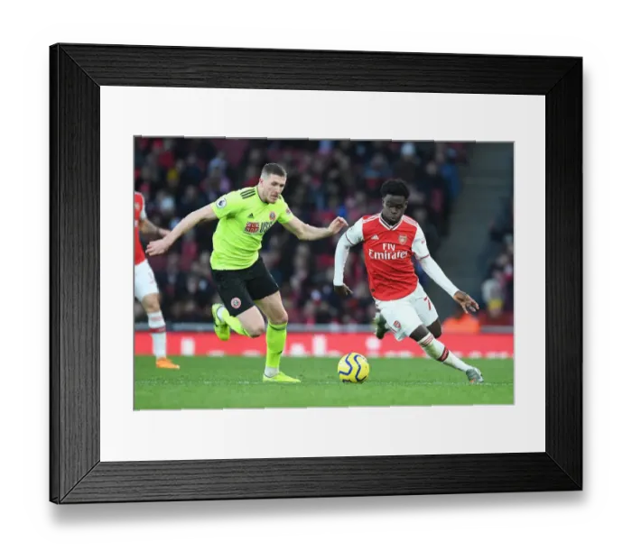 Framed Print : Intense Showdown: Bukayo Saka vs. John Lundstram in Arsenal's Battle Against Sheffield United Framed Print : Intense Showdown: Bukayo Saka vs. John Lundstram in Arsenal's Battle Against Sheffield United