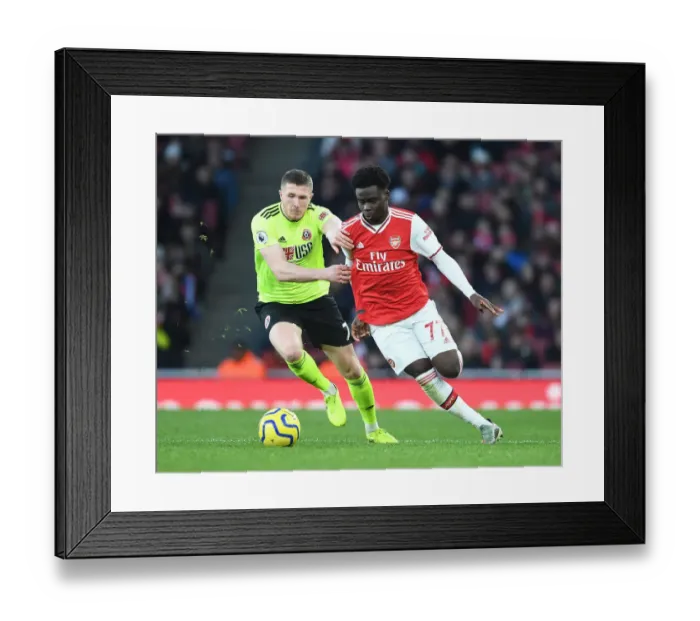 Framed Print : Intense Rivalry: Bukayo Saka vs. John Lundstram's Battle in Arsenal's Clash Against Sheffield United Framed Print : Intense Rivalry: Bukayo Saka vs. John Lundstram's Battle in Arsenal's Clash Against Sheffield United