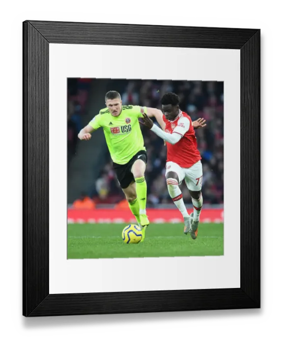 Framed Print : Saka vs. Lundstram: A Premier League Showdown - Arsenal's Bukayo Saka Tangles with Sheffield United's John Lundstram Framed Print : Saka vs. Lundstram: A Premier League Showdown - Arsenal's Bukayo Saka Tangles with Sheffield United's John Lundstram