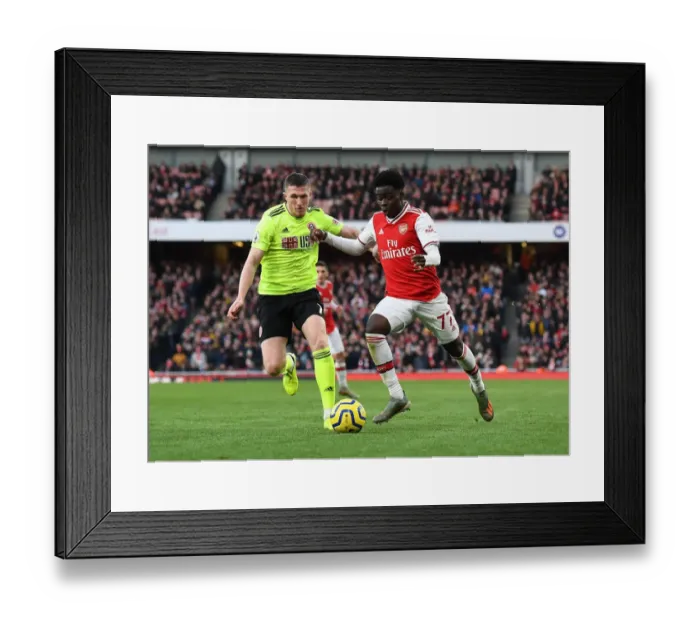 Framed Print : Intense Battle: Bukayo Saka vs. John Lundstram - Arsenal's Clash Against Sheffield United
