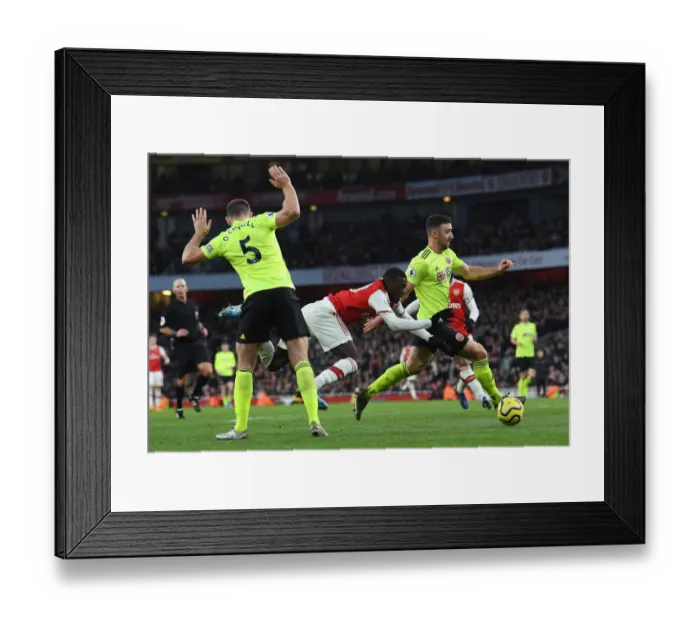 Framed Print : Arsenal vs Sheffield United: Pepe Faces Off Against Defenders