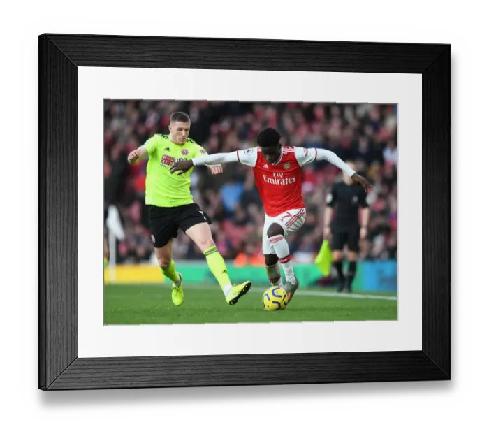 Framed Print : Intense Battle: Bukayo Saka vs. John Lundstram - Arsenal's Clash Against Sheffield United Framed Print : Intense Battle: Bukayo Saka vs. John Lundstram - Arsenal's Clash Against Sheffield United