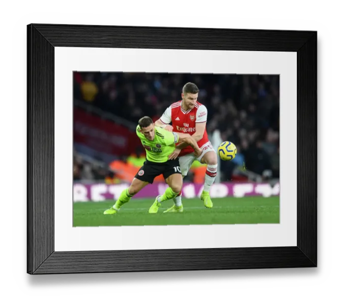Framed Print : Mustafi vs. Sharp: A Premier League Battle - Arsenal vs. Sheffield United's Intense Clash Framed Print : Mustafi vs. Sharp: A Premier League Battle - Arsenal vs. Sheffield United's Intense Clash