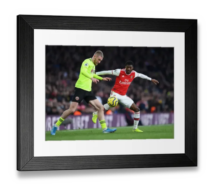 Framed Print : Arsenal vs Sheffield United: Ainsley Maitland-Niles Closes Down Oli McBurnie in Intense Premier League Clash Framed Print : Arsenal vs Sheffield United: Ainsley Maitland-Niles Closes Down Oli McBurnie in Intense Premier League Clash