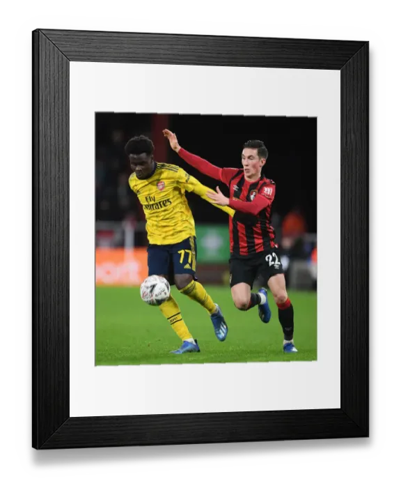 Framed Print : Arsenal's Bukayo Saka Outmaneuvers Bournemouth's Harry Wilson in FA Cup Fourth Round Clash Framed Print : Arsenal's Bukayo Saka Outmaneuvers Bournemouth's Harry Wilson in FA Cup Fourth Round Clash