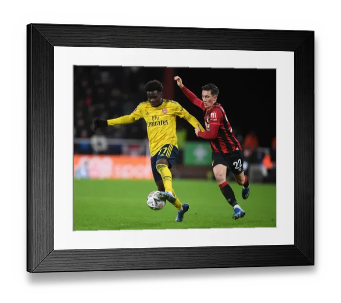 Framed Print : Arsenal's Bukayo Saka Outmaneuvers Harry Wilson in FA Cup Clash Framed Print : Arsenal's Bukayo Saka Outmaneuvers Harry Wilson in FA Cup Clash