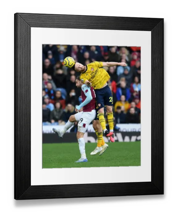 Framed Print : Mustafi Heads Off Burnley Challenge: Arsenal vs. Burnley, Premier League 2019-20