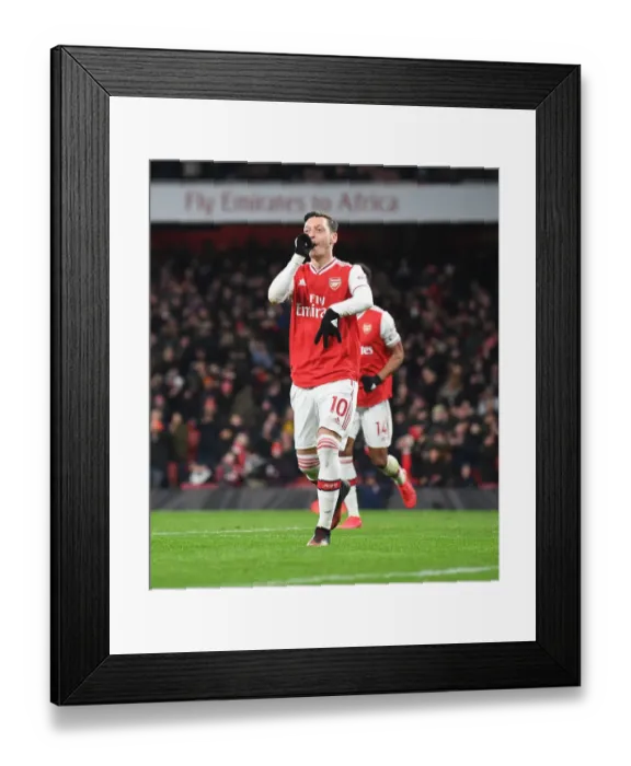 Framed Print : Mesut Ozil Scores Third Goal: Arsenal FC Triumphs Over Newcastle United in Premier League