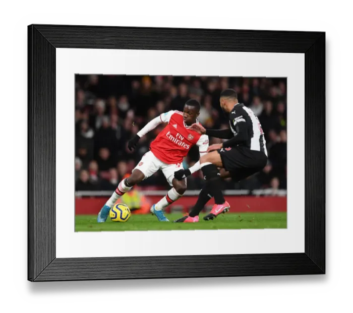 Framed Print : Arsenal vs Newcastle United: Eddie Nketiah Clashes with Jamaal Lascelles in Premier League Showdown
