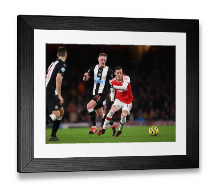 Framed Print : Arsenal vs Newcastle: Ozil Clashes with Longstaff in Premier League Showdown