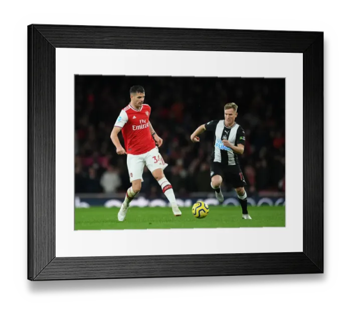 Framed Print : Arsenal's Xhaka Fends Off Newcastle's Ritchie During Premier League Clash Framed Print : Arsenal's Xhaka Fends Off Newcastle's Ritchie During Premier League Clash
