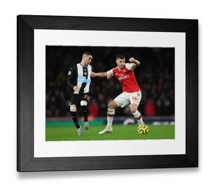 Framed Print : Arsenal's Granit Xhaka Holds Off Newcastle's Miguel Almiron During Premier League Clash Framed Print : Arsenal's Granit Xhaka Holds Off Newcastle's Miguel Almiron During Premier League Clash