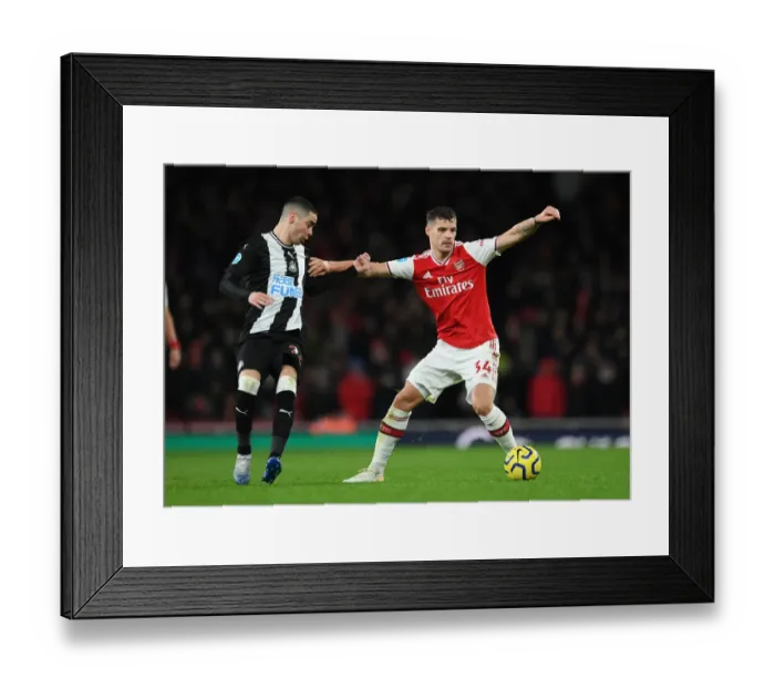 Framed Print : Arsenal's Xhaka Holds Off Newcastle's Almiron in Premier League Clash Framed Print : Arsenal's Xhaka Holds Off Newcastle's Almiron in Premier League Clash