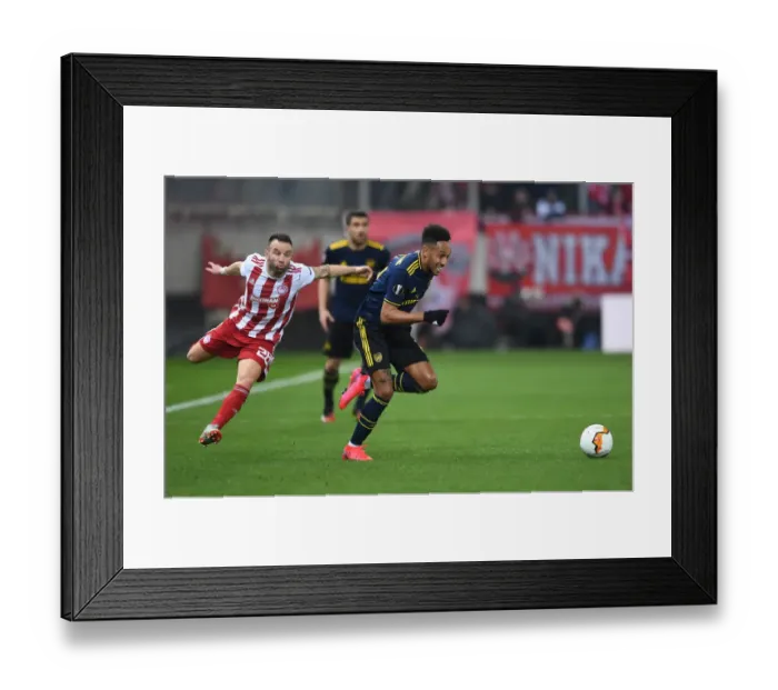 Framed Print : Arsenal's Aubameyang Clashes with Olympiacos Valbuena in Europa League Showdown