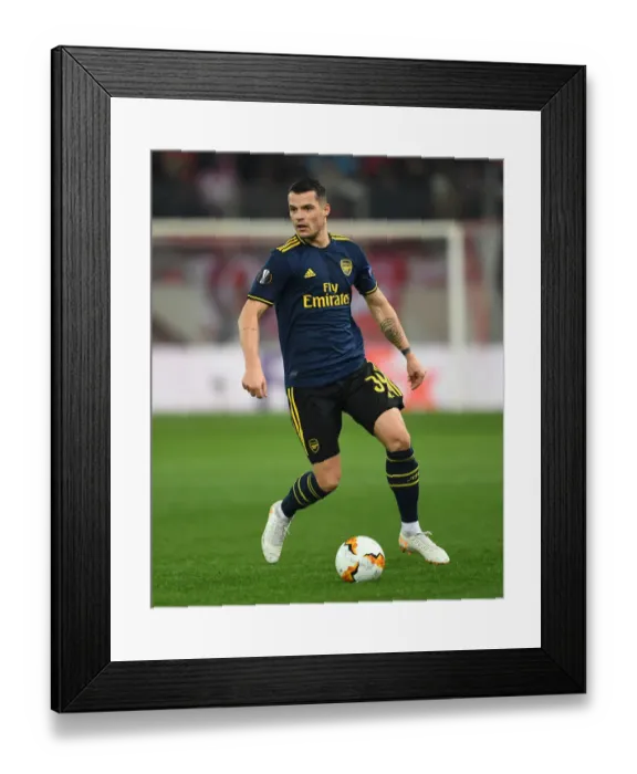 Framed Print : Granit Xhaka in Action: Arsenal vs. Olympiacos, UEFA Europa League Round of 32 (Piraeus, 2020) Framed Print : Granit Xhaka in Action: Arsenal vs. Olympiacos, UEFA Europa League Round of 32 (Piraeus, 2020)