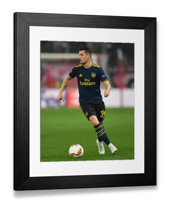 Framed Print : Granit Xhaka in Action: Olympiacos vs. Arsenal, UEFA Europa League Round of 32 (Piraeus, 2020)