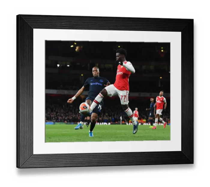 Framed Print : Arsenal's Bukayo Saka Clashes with Everton's Djibril Sidibe in Premier League Showdown Framed Print : Arsenal's Bukayo Saka Clashes with Everton's Djibril Sidibe in Premier League Showdown