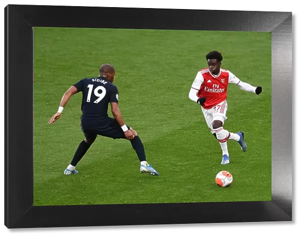 Arsenal's Bukayo Saka Evades Everton's Djibril Sidibe: Premier League Showdown at Emirates Stadium