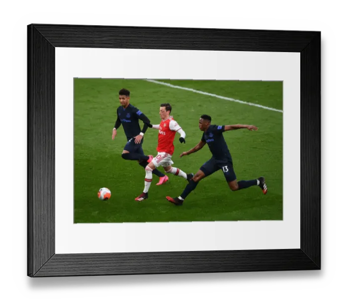Framed Print : Arsenal vs Everton: Ozil Faces Off Against Holgate and Mina in Intense Premier League Clash