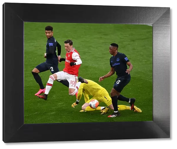 Arsenal's Ozil Faces Intense Pressure from Everton's Holgate, Mina, and Pickford