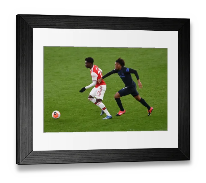 Framed Print : Arsenal's Bukayo Saka Clashes with Everton's Alex Iwobi in Premier League Showdown Framed Print : Arsenal's Bukayo Saka Clashes with Everton's Alex Iwobi in Premier League Showdown