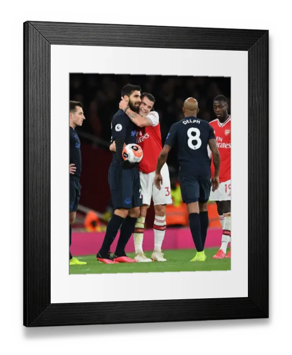 Framed Print : Arsenal's Xhaka and Gomes Embrace Amidst Premier League Rivalry Framed Print : Arsenal's Xhaka and Gomes Embrace Amidst Premier League Rivalry