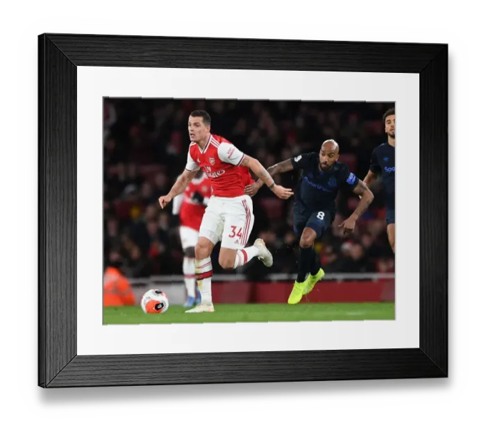 Framed Print : Arsenal's Xhaka Clashes with Everton's Delph in Premier League Showdown